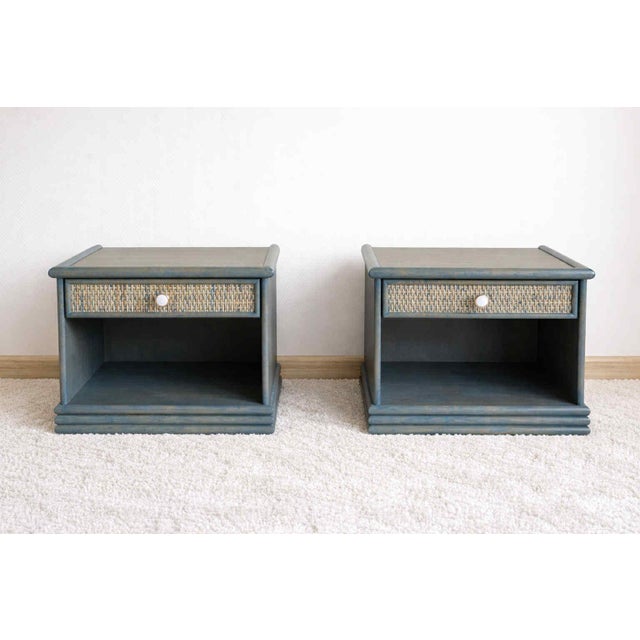 Pair of bedside tables in blue-stained rattan, in the style of vintage 1980s designs. Rectangular shape, one drawer on the...