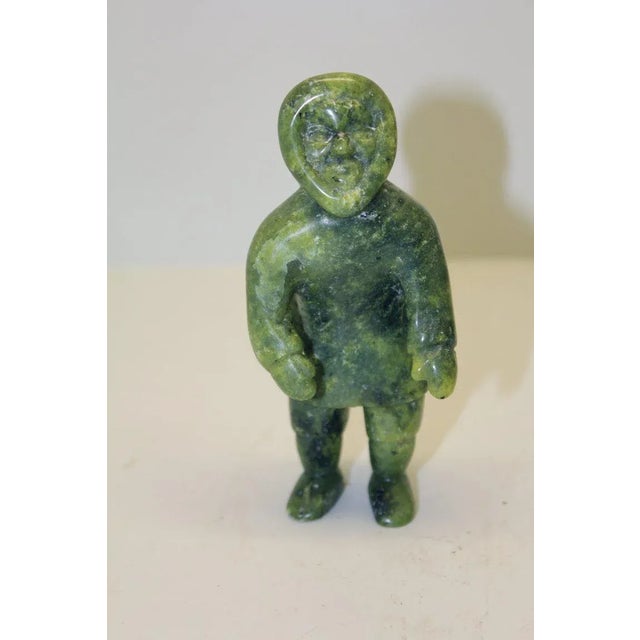 An Inuit carving of a man signed on the base. Great Color. It appears to be a soapstone carving. Great color and...