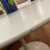 It’s beautiful and authentic and a great deal. Gently used tulip dining table in white laminate. White base, which is...