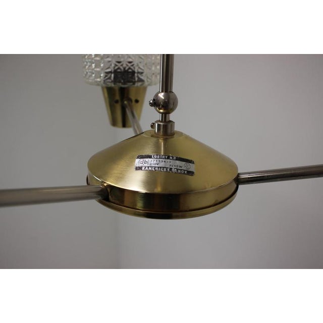 Chandelier made by Kamenicky Senov in the 1970's, in Czechoslovakia. Made of brass, metal and glass. In good original...