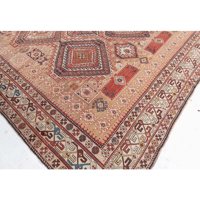 This outstanding antique Shirvan rug exemplifies the artistry of early 20th-century Caucasian weaving. Handwoven in the...