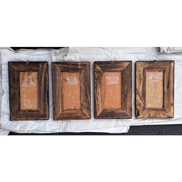 A collection of antique Italian hand painted terracotta tiles depicting the four seasons. Each is framed in poplar in a...