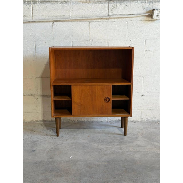 Beautiful vintage Danish Modern cabinet/bookcase crafted in teak with clean Scandinavian lines and elegant tapered legs....