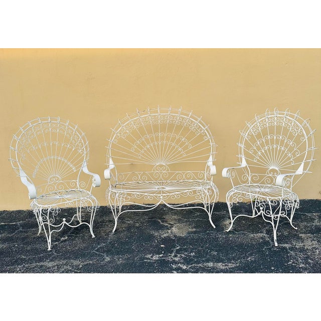 A stunning MidCentury set totally original 2 peacock chairs with matching bench, very intricate design made of wrought...