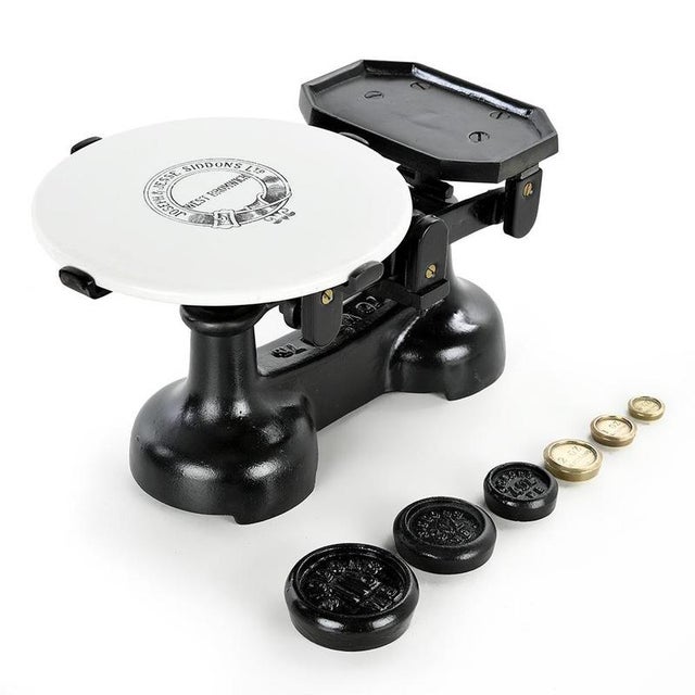 This charming 20th century Joseph & Jesse SIDDONS Ltd English scale is a period piece made of ceramic and cast iron, a...