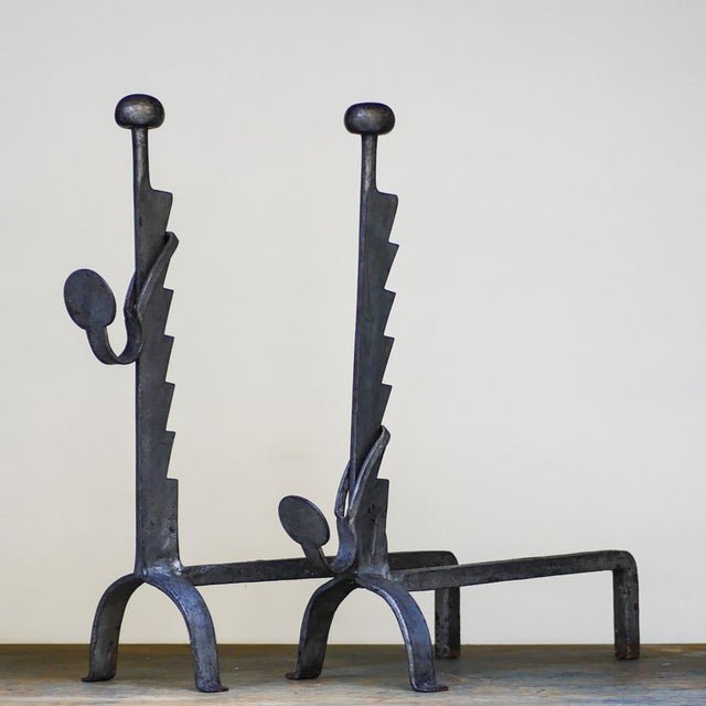 A Pair of Big fireplace andirons. Italian production. Unique pieces. In wrought iron. Zoomorphic design. Brutalist style....