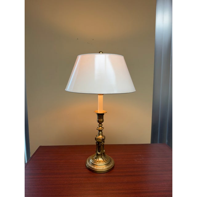 A finely detailed Neoclassical table lamp crafted entirely from solid brass. The base features ornate classical detailing...