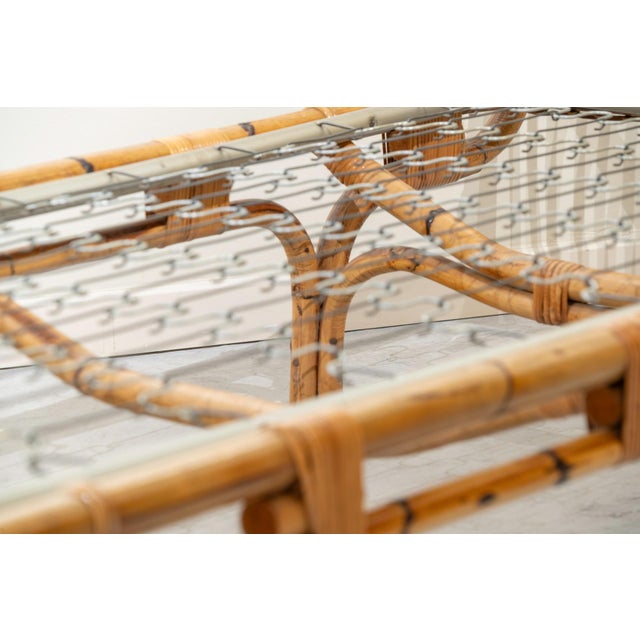 A bed made of Italian bamboo from the 1960s, 90 cm wide. The headboard is taller than the footboard, and it features an...