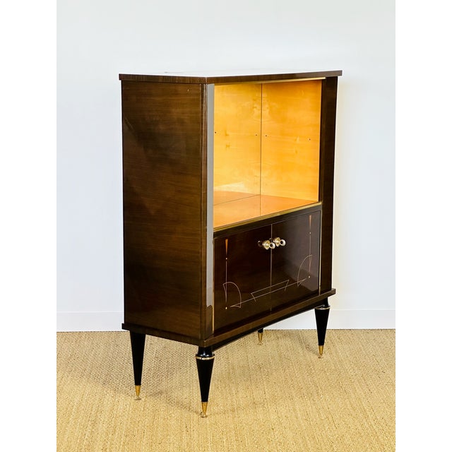 Sublime 1950s Art Deco-style display cabinet, in excellent overall condition. This refined sideboard is distinguished by...