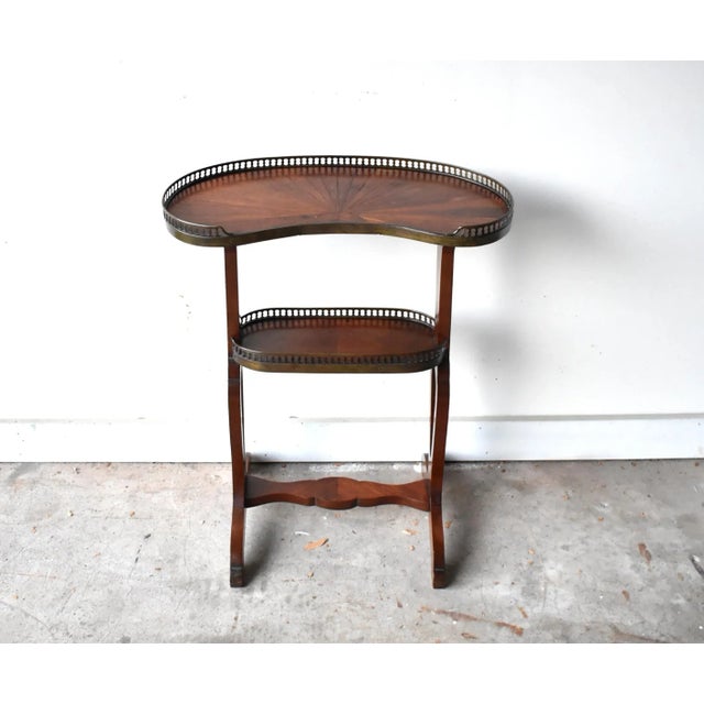 An antique, late 19th- to early 20th-century, French "rognon" or kidney-shaped side table or work table, used to pull up...