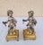 Pair of silver-plated bronze putti seated on ormolu fluted truncated columns, standing on pedestals with ball feet. Good...