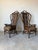 Beautiful vintage pair of high back arm chairs featuring bent rattan frames, woven wicker panels, decorative wrapped...