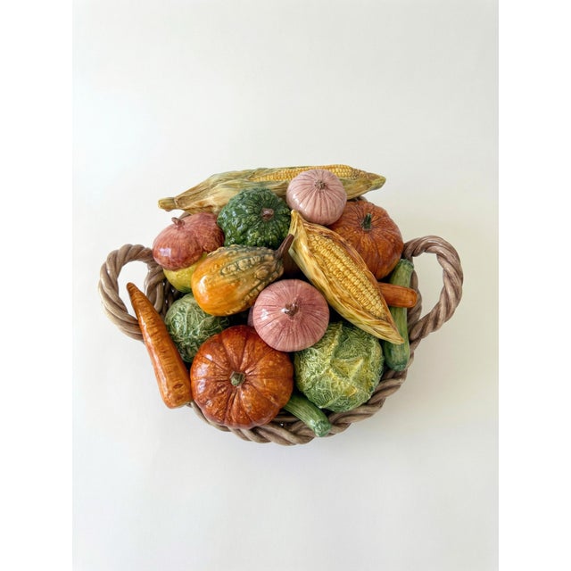 A charming and whimsical Italian ceramic centerpiece basket, featuring a colorful array of sculpted vegetables. This...
