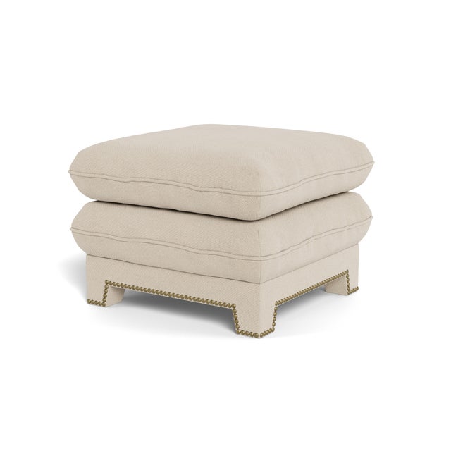 A dreamy, cloud-like upholstered pouf with tapered legs and French nailhead trim. An inviting pull-up ottoman - a pair of...