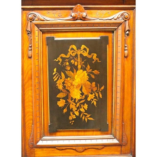 An antique ebonized walnut credenza, dating to approximately 1880, showcases elaborate marquetry and inlay work. This...