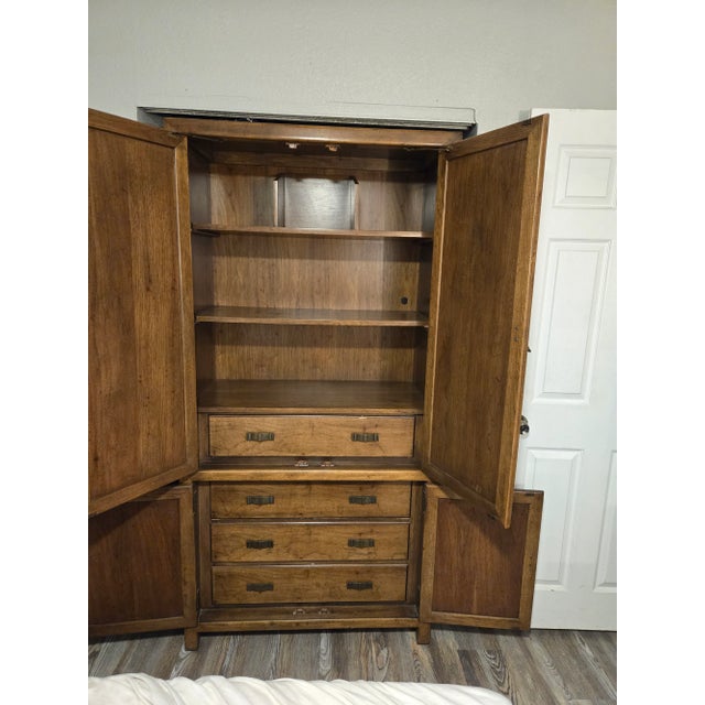 The furniture is a Century Furniture brutalist cabinet or armoire. Similar designs are often found in the brutalist style,...