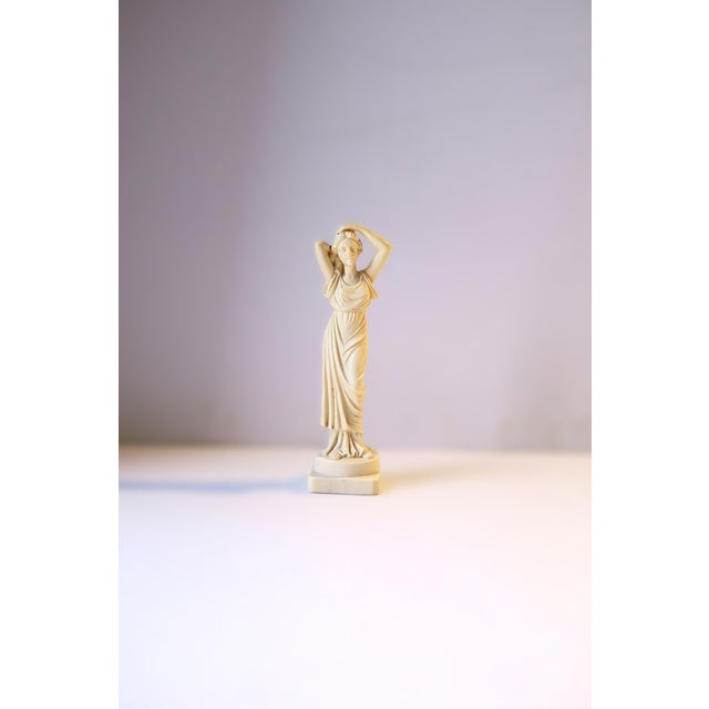 An Italian female resign sculpture statue in the Neoclassical design style, circa mid-20th century, 1950s, Italy....