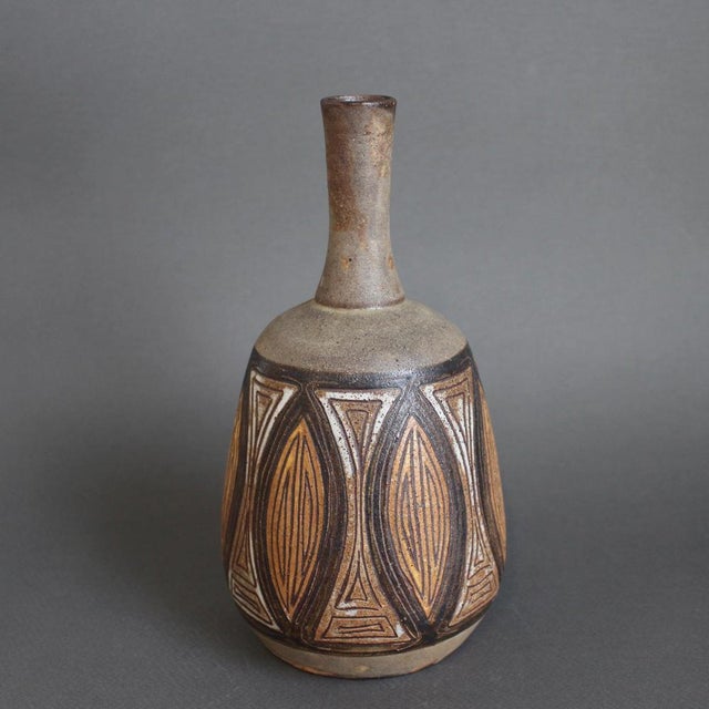 French ceramic flower vase by Alexandre Kostanda, Vallauris, France (circa 1960s). In his trademark natural clay and...