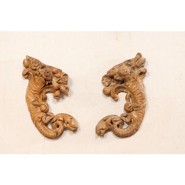 A French pair of carved-wood cornucopia wall decorations from the turn of the 18th and 19th century. This antique pair of...