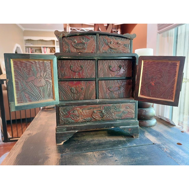 Elevate your space with this striking antique Chinese Hand-Stained and Gilt Dragon Cabinet. Its exquisite craftsmanship...
