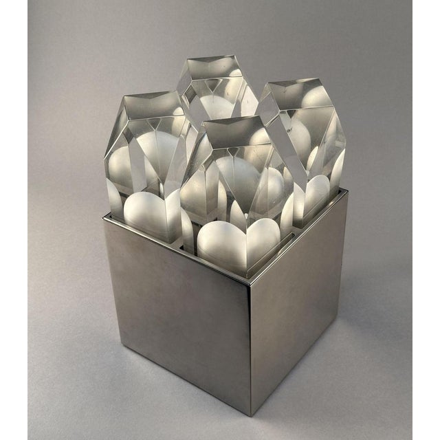 Rare sculptural table light consist of four polyhedral shaped acrylic glas shades set in a stainless steel box shape...