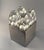 Rare sculptural table light consist of four polyhedral shaped acrylic glas shades set in a stainless steel box shape...