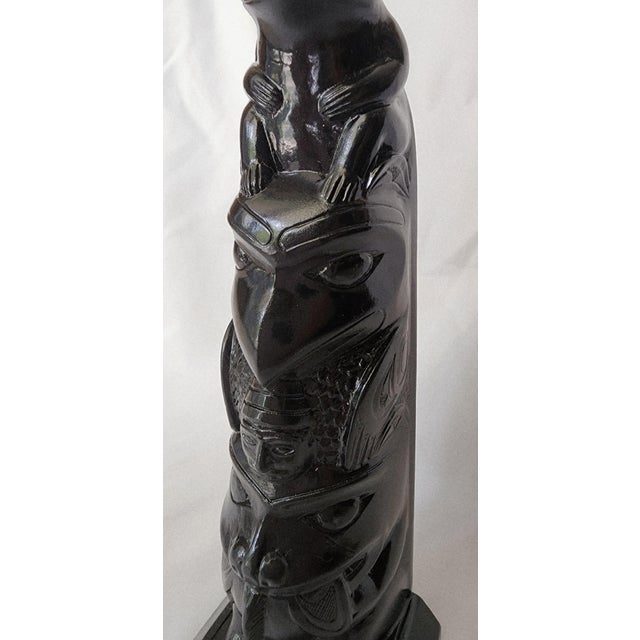 Stunning Hand Carved 5-Figure Totem Featuring a Frog, Falcon, man, Bear and Fish. A replica carved between the 1930s and...
