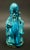 Painted in shades of turquoise and teal, this statue features a Buddhist monk. Depicted with a knowing smile, the monk...