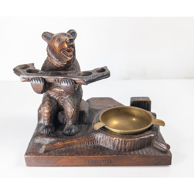 We are selling this 20th century German Black Forest carving. This carving features a bear holding a shelf with five holes...