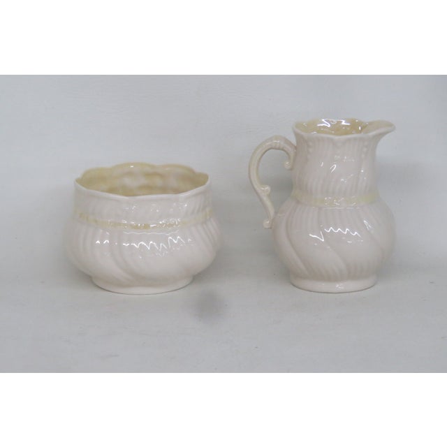 This lovely Creamer and Sugar Bowl set is made out of porcelain. This set is stamped as being made by Belleek in Ireland,...
