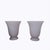 A pair of goblet-shaped lamps with narrow, stepped bases and wide openings that project light upwards. Made of frosted...