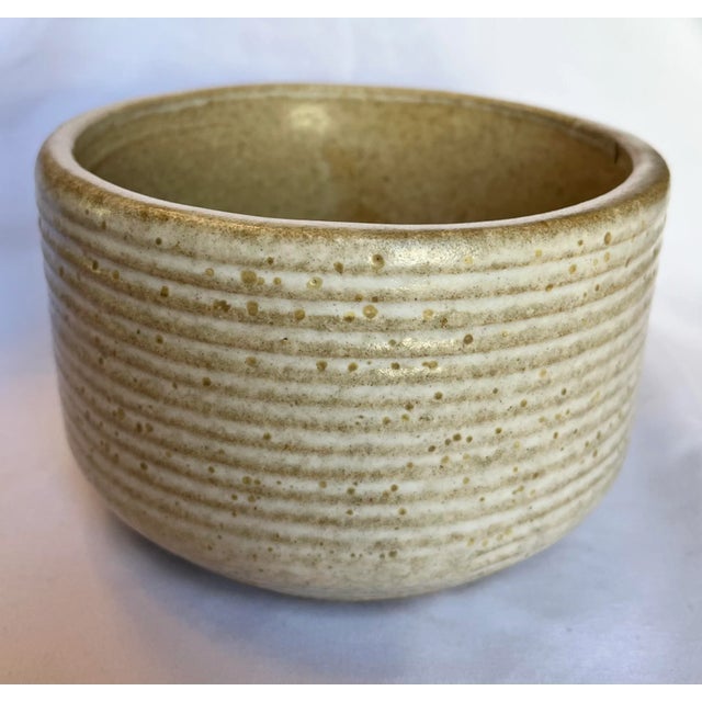 Vintage Zanesville Pottery hand thrown 7005 bowl in a stunning natural glaze with pitted texture and ribbed finish. The...