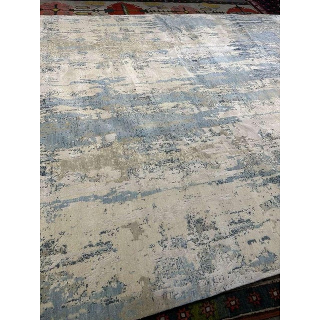 This hand-knotted rug from Nepal is a refined study in texture, material, and understated design. Measuring 10' x 14', it...