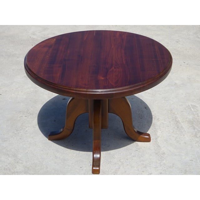 Coffee table, 70 cm in diameter, made of cherry wood. Tabletop 38 mm thick. Central four-legged base with curved edges for...