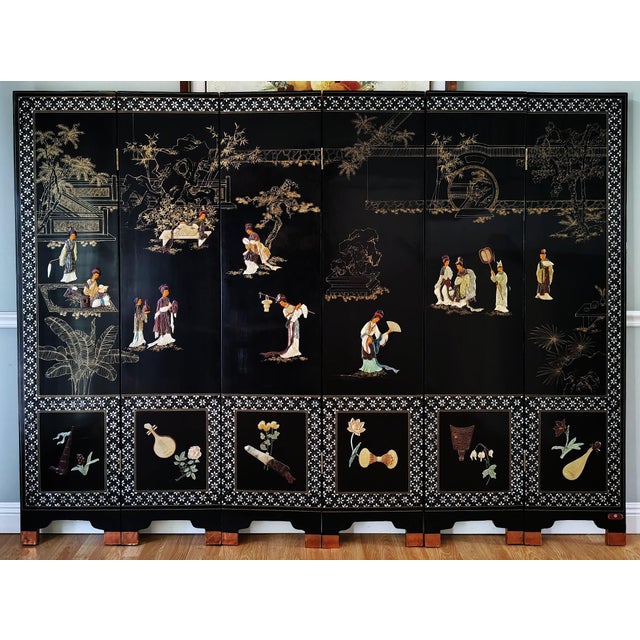 This beautiful Chinese export six panel lacquered coromandel screen features hand-carved soapstone of ladies in leisure...