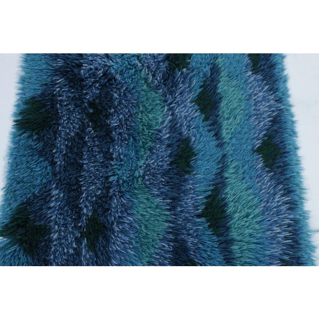 Hand-knotted in lush, high-pile wool in Sweden circa 1960-1970, this 2x4 vintage Swedish Rya runner rug is a bold new...