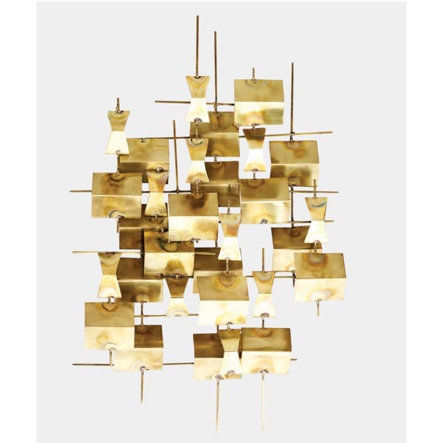 Striking folded brass wall sculptures designed by Dwell Studio for Global Views, featuring an intricate, dimensional...