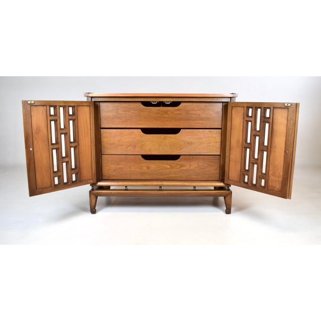 A multi-purpose cabinet by White Furniture of Mebane expertly made with walnut burled case construction in the dramatic...