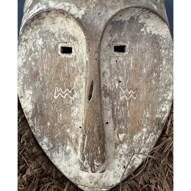 Add a touch of culture with this striking tribal mask. Its intricate design and feather decor makes it a captivating...