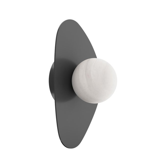 The Rhoads Sconce captures the collection’s sculptural purity in a singular, elegant form. A softly curved triangular...