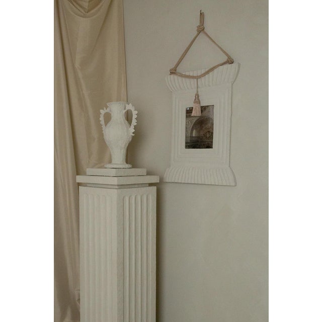 The Elisabetta Frame is hand wrapped in papier mâché, bringing a sculptural, artisanal quality to the wall. Its fluted...