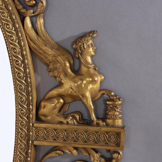 Antique Egyptian Revival Neoclassical Gilt Bronze Oval Mirror Unsigned C1890 Measures - 54" x 30 7/8" x 1 3/4" An antique...