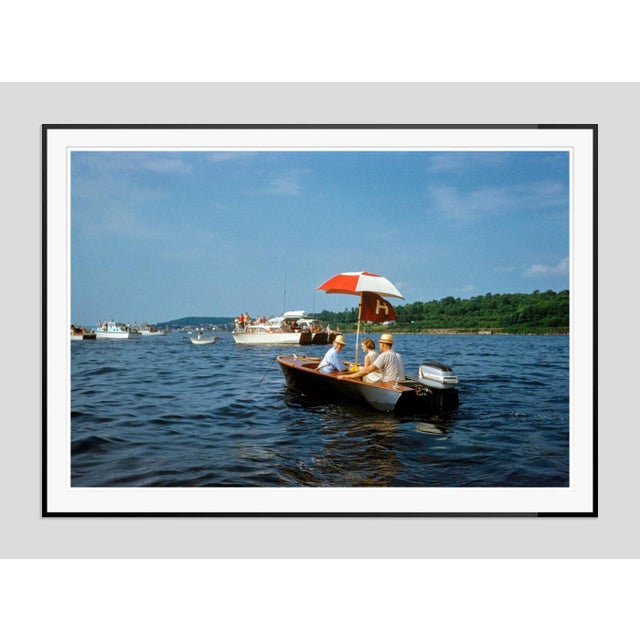 Harvard-Yale Regatta by Toni Frissell A vintage wooden boat carries passengers during the Harvard-Yale Regatta, circa...