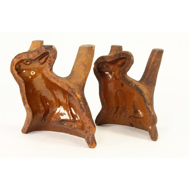 An early and RARE find A pair of redware molds featuring seated rabbits, larger and smaller The interior is glazed, the...