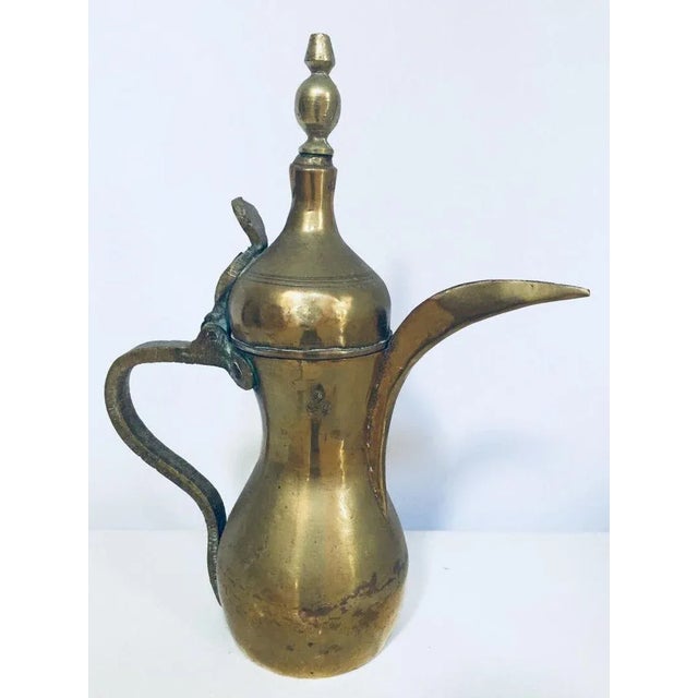 Middle Eastern traditional Arabian brass Dallah coffee pot. Coffee pot hand-hammered and chased brass with riveted brass...