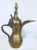 Middle Eastern traditional Arabian brass Dallah coffee pot. Coffee pot hand-hammered and chased brass with riveted brass...