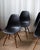 A classic set of four Design Within Reach Eames molded plastic dining chairs with warm wood dowel legs. Timeless mid-...