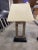 A sleek and sculptural pair of modern table lamps featuring a minimalist open-frame design in brushed metal. Anchored on...