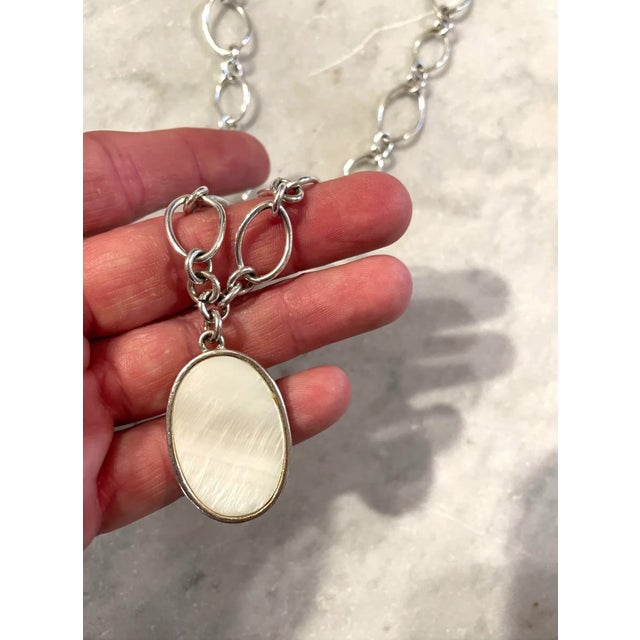 Lovely vintage sterling silver chain link necklace with oval mother of pearl pendant with lobster claw clasp.