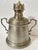 This vintage pewter lamp features a classic oil lantern design with a central wick burner, a fount for holding fuel, and...